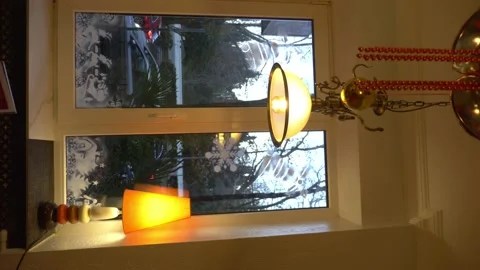 Vertical. window with Christmas patterns on the glass and a lamp on the Stock-Footage 146237837