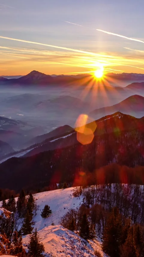 Vertical Winter Sunrise Over Snow-Capped Mountains with Fog in the Valley Stock Footage 296753206