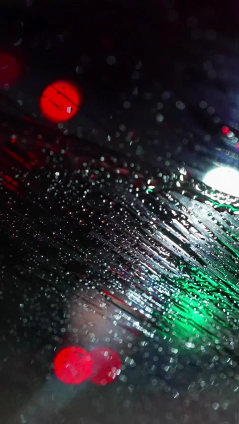 Vertical wipers wipe the windshield from water. Bokeh of police flashing lights Stock Footage 292217082