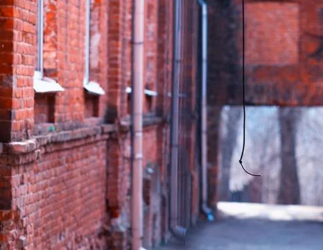 Vertical wire at red bricked yard background Stock Photos
