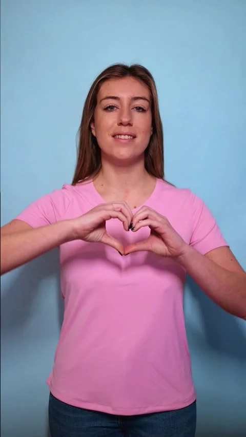 Vertical Woman making heart shape with hands for breast cancer awareness Stock Footage 313733339