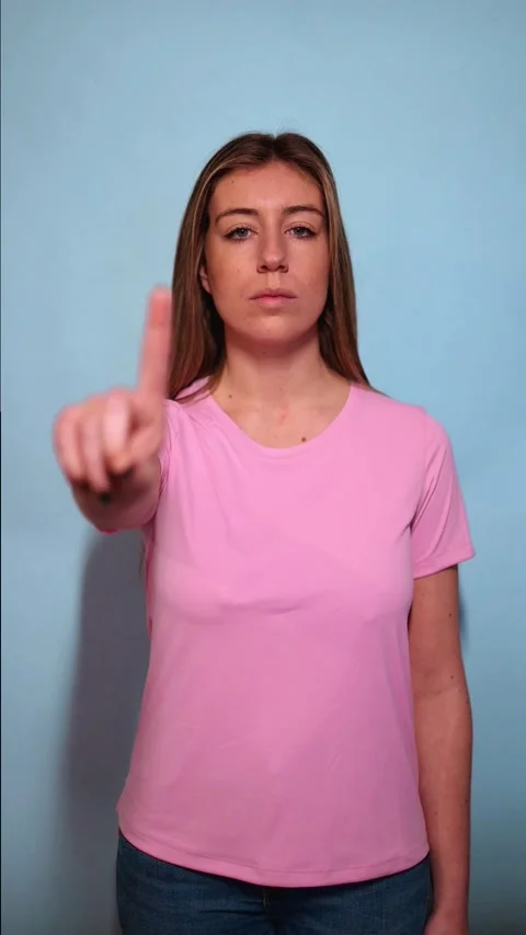 Vertical Woman raising index finger on blue background Stock Footage 313733341