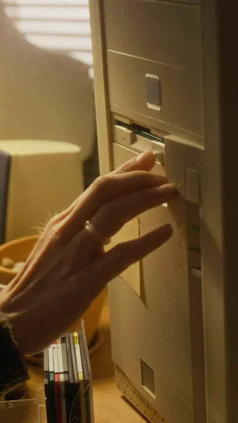 Vertical of Woman Removing Floppy Disk while Working on Computer in 1990s Stock Footage 327239042