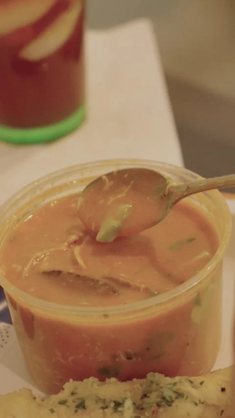 Vertical Womans hand mixing  hot soup in to go container Stock Footage 284041489