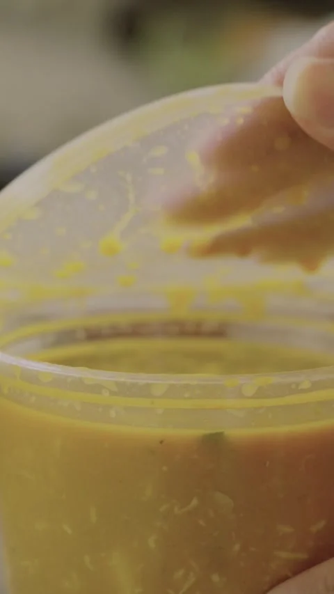 Vertical Womans hands taking off to go lid on soup container Video stock 284033424