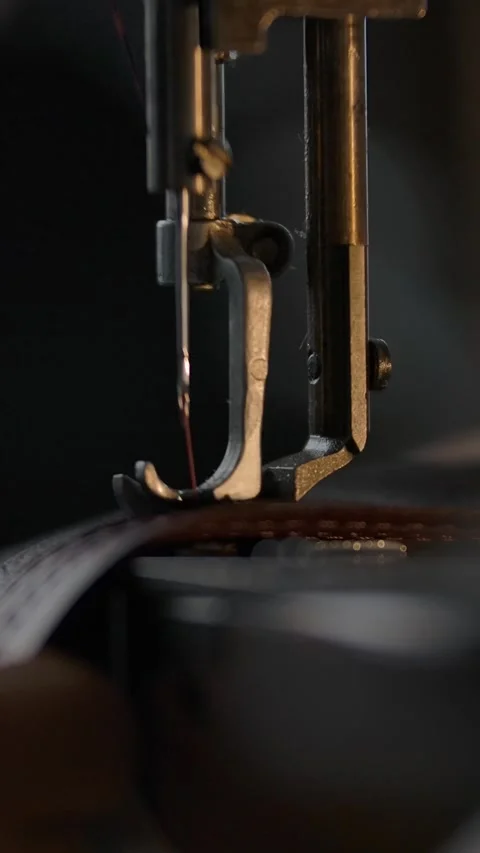 Vertical of Working sewing machine presser foot, stitching in slowmotion. Tailor Stock Footage 276934156