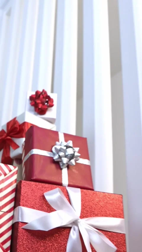 Vertical Wrapped gift boxes under a Christmas decoration tree home, Happy Xmas Stock Footage 316489153