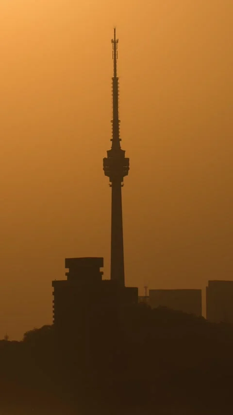 Vertical Wuhan TV Tower Sunset Timelapse with Golden Sun and Urban Nightfall Stock Footage 327479798
