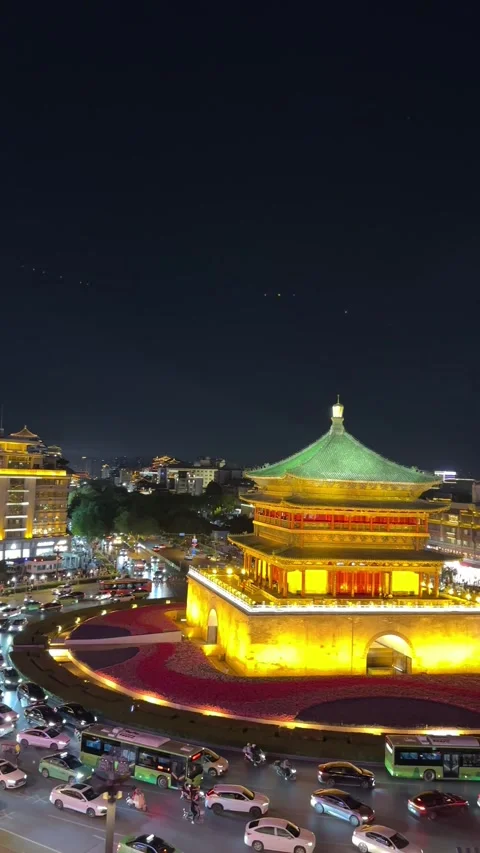 Vertical Xian Bell Tower night view with traffic flow around roundabout Chin Stock Footage 335809758