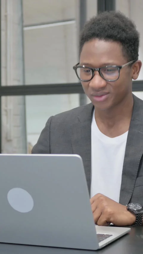 Vertical, Young African Man Doing Video Chat via Laptop Vídeo Stock 325559279