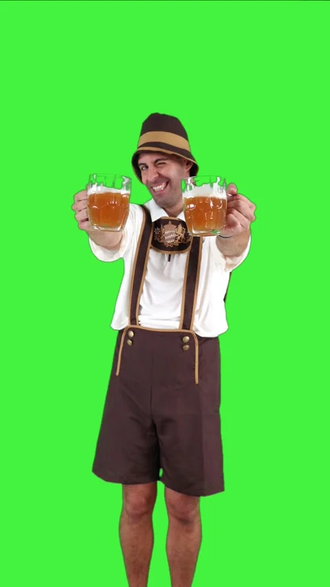 Vertical young bavarian man toasting with two beer glasses and winking at c.. Stock Footage 281192361