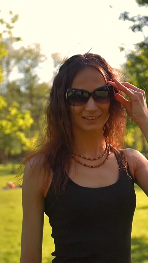 Vertical of Young beautiful red-haired female in the summer on the nature puts Stock Footage 278485187