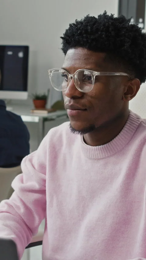Vertical of Young Black Male Developer with Glasses Smiling in Office Video stock 330157372