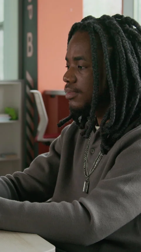 Vertical of Young Black Programmer Working on Computer in Office Video stock 333570353
