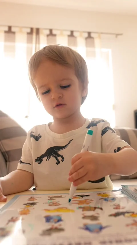 Vertical of Young Boy Teaching and Reading Books at a Cozy Table Stock Footage 274145501