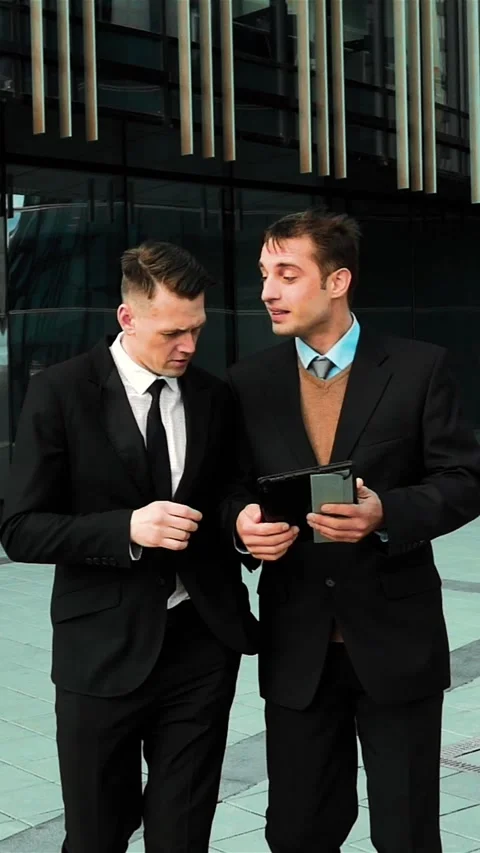 Vertical of Young businessmen using digital pad Stock Footage 305511616