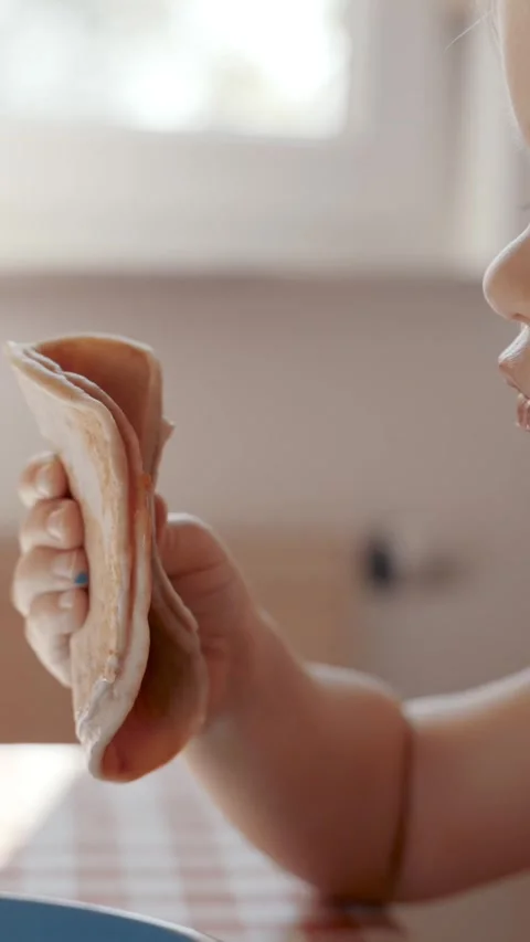 Vertical of Young Child Eating at Table Stock Footage 274144983