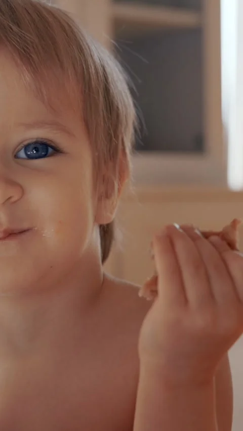 Vertical of Young Child Sitting at Table With Food Stock Footage 274145004