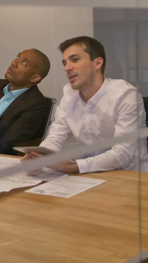 Vertical of Young colleagues team sitting at a table, man with virtual reality Stock Footage 277280189