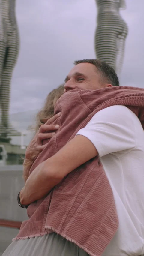 Vertical. A young couple hug each other outdoor,in park,slow motion Stock Footage 294068516