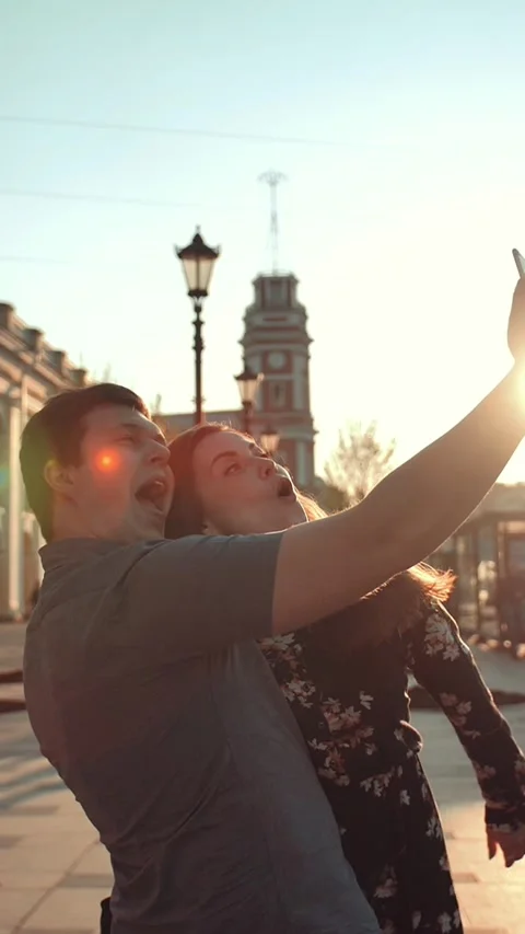 Vertical of Young couple taking selfies at city big road avenue Stock Footage 278485208