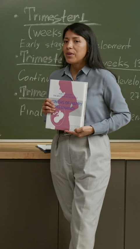 Vertical of Young Female Teacher Talking about Fetus Development at Lesson Stock Footage 333739351