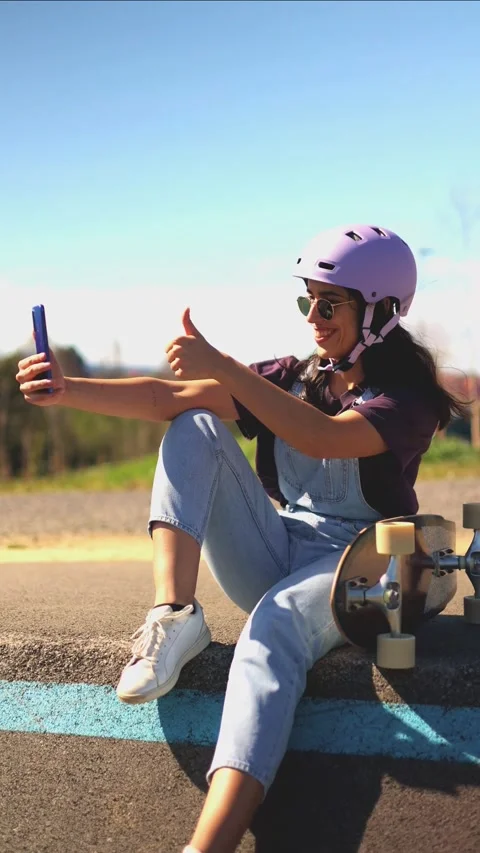 Vertical Young latin skater taking a selfie and giving a thumbs up Stock Footage 308742890