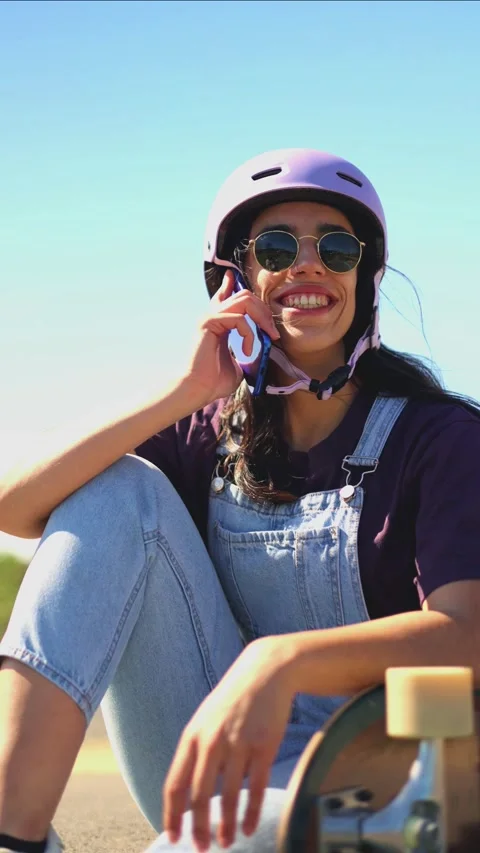 Vertical Young latin skater talking on phone Stock Footage 308742887