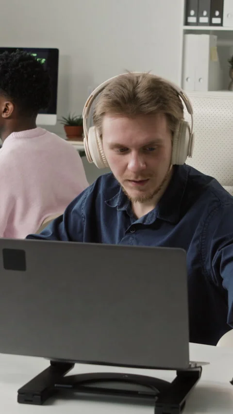 Vertical of Young Male Developer Stretching Arms while Working on Office Laptop Stock Footage 330158787