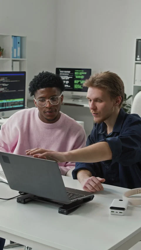 Vertical of Young Male Programmer Asking Colleague Question in Office Stock-Footage 330132934
