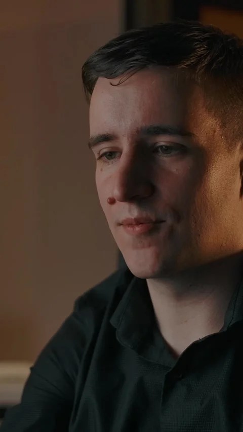 Vertical of Young man communicates online via phone in a cozy apartment Stock Footage 276925206