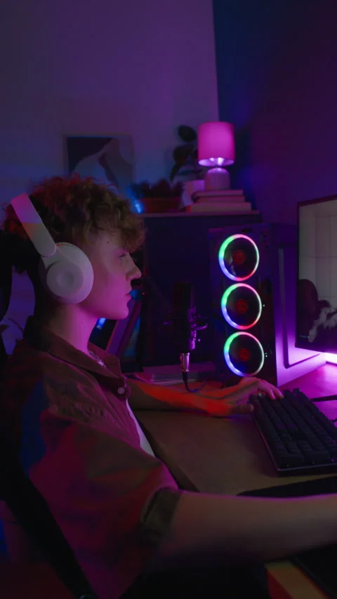 Vertical of Young Man Playing Computer Game Pressing Keyboard Keys Stock Footage 314667117
