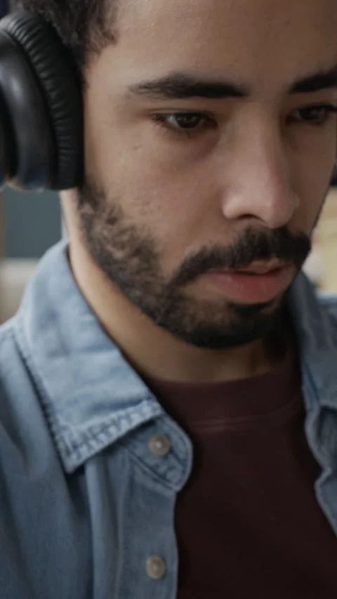 Vertical of Young Middle Eastern Man in Headphones Typing on Keyboard Stock Footage 337477534