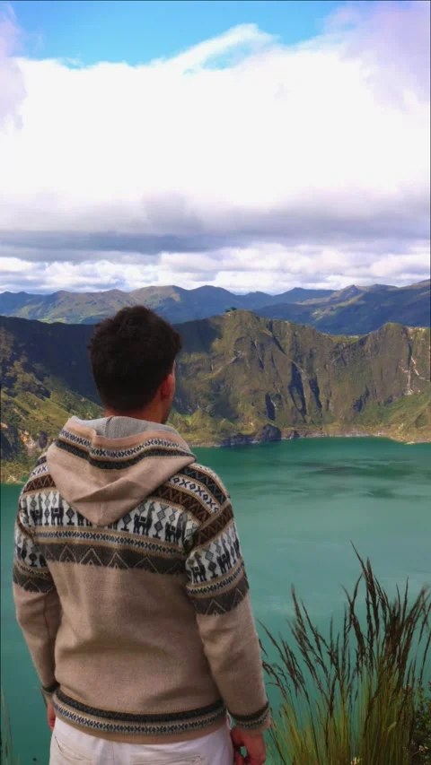 Vertical Young person seen from behind observing Quilotoa Lagoon in the Ecu.. Stock Footage 280338492