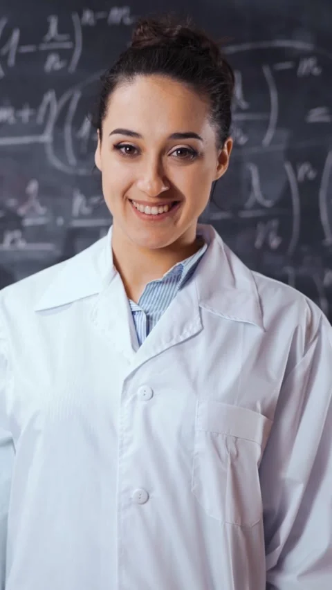 Vertical of Young student female solve hard equation on black chalk board Stock Footage 305484391