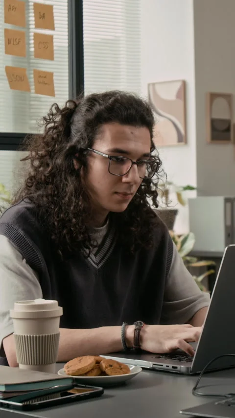 Vertical of Young Web Developer Writing Code on Laptop at Desk during Workday 動画素材 329618311