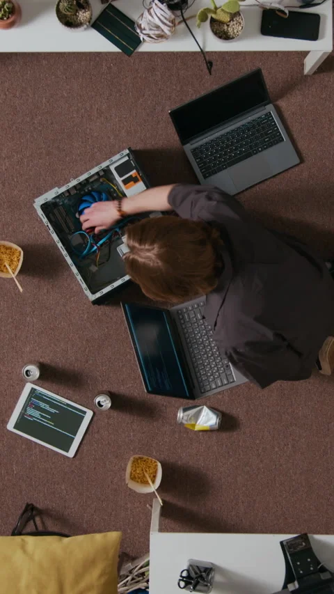 Vertical of Young Web Engineer Working with Cables Leaning over Open PC Case Stock Footage 312451801