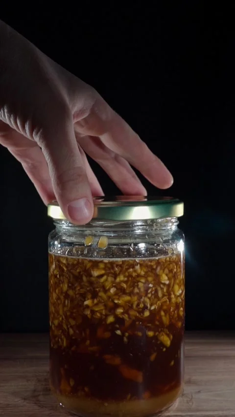 Vertical Zoom Out Hand Opening Fermented Ginger Honey Jar Lid Slow Motion Stock Footage 324921546