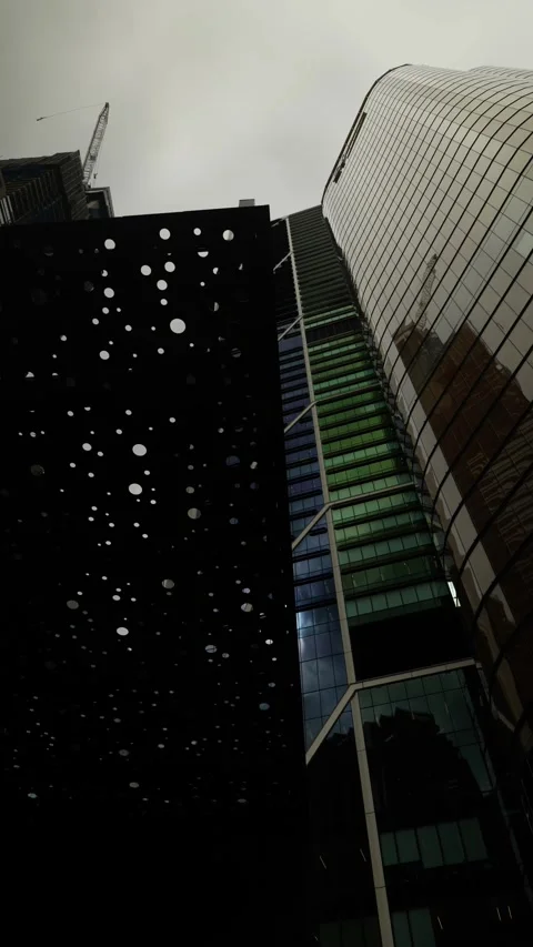 Vertical zoom out reflected crane on modern architecture 4K Video stock 309973813