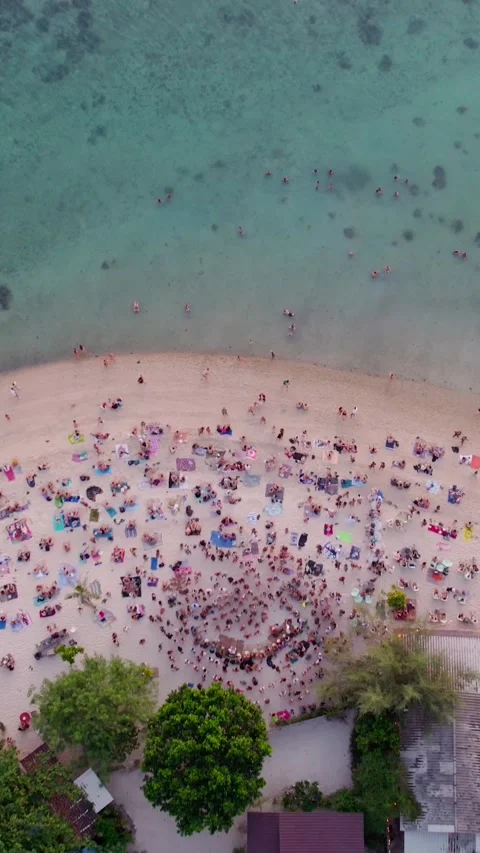 Vertical.Drone sunset shot of crowds of people dancing and having fun on a zen Stock Footage 320529607