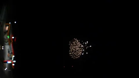 Vertically. blurry flashes of fireworks in the distance in the night Stock-Footage 136146047