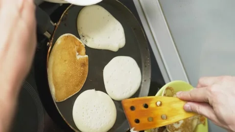Vertically. close up, someone is cooking pancakes in a pan on a stove touch Stock Footage 131035850