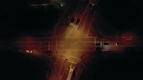 Vertically filmed drone video of a road intersection with moving vehicles at Stock Footage 149686608