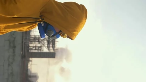 Vertically. man in respirator against the background of factory chimneys Stock Footage 130704601