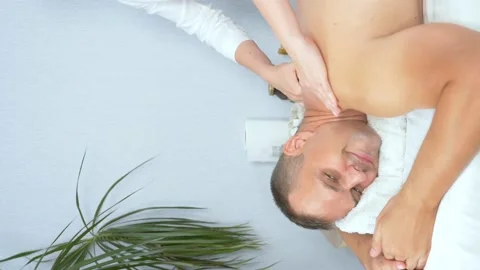 Vertically. masseuse doing medical back massage to man in spa salon Stock Footage 139103820