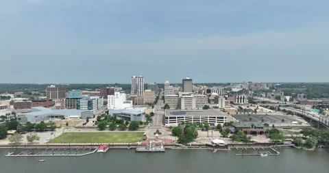Vertically rising then forward flight viewing the city from the river Stock Footage 250583208