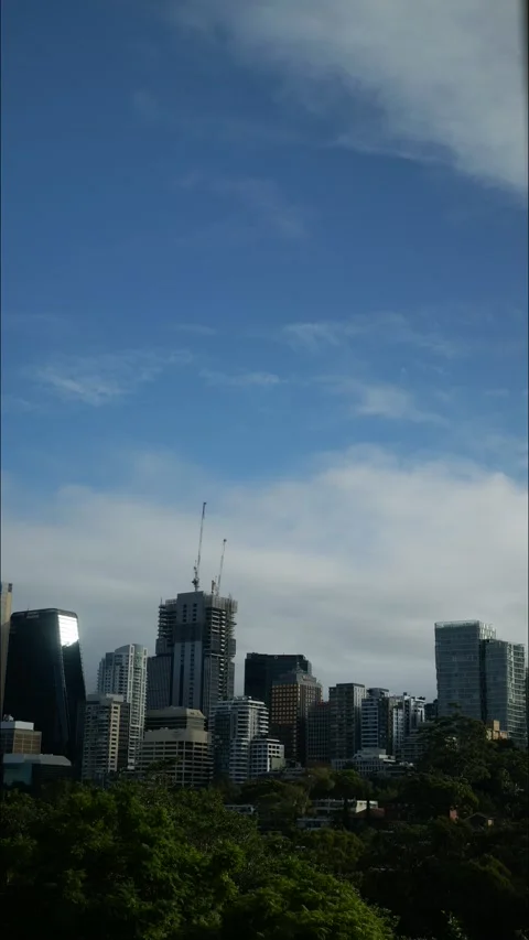 Vertical.time lapse sunlight bounces off a skyscraper 4K Stock Footage 309014466
