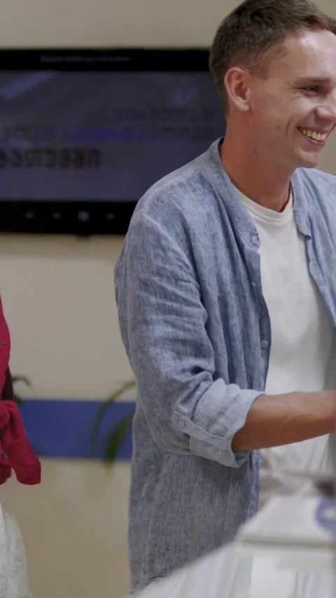Vertical.Young couple casually interacting at the reception desk. Slowmotion Stock Footage 294068655