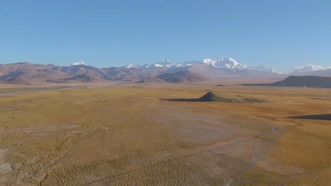 VERTIGO Flying across the arid plains and towards the snow capped mountain range Stock Footage