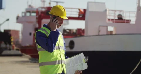 A very angry dock worker taking a call on his mobile. Shot on RED Epic. Stock Footage 55360801